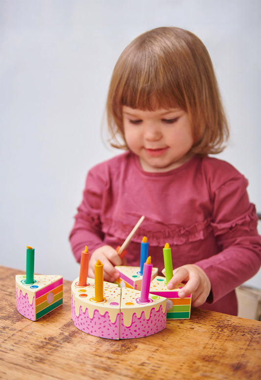 Petite fille jouant à découper un gâteau dinette en bois multicolore – jouet d’imitation Tender Leaf Toys
