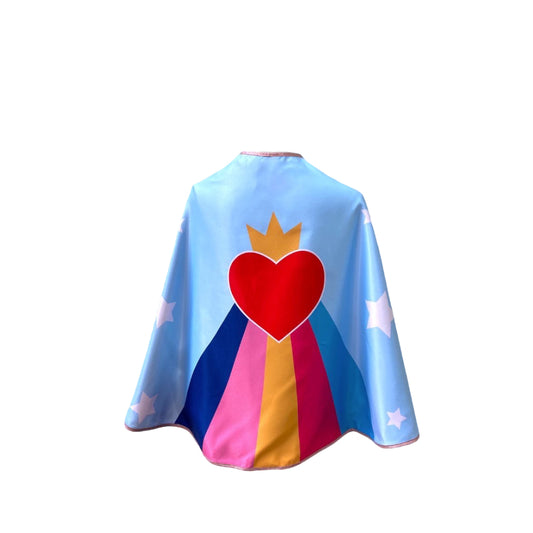 Cape de princesse super-hero, fond bleu ciel avec arc en ciel et coeur couronné. Pour les filles dès 3 ans. Taille unique enfant adulte.