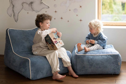 Enfants assis sur fauteuil Kumo et ottoman Shappy pendant un moment lecture